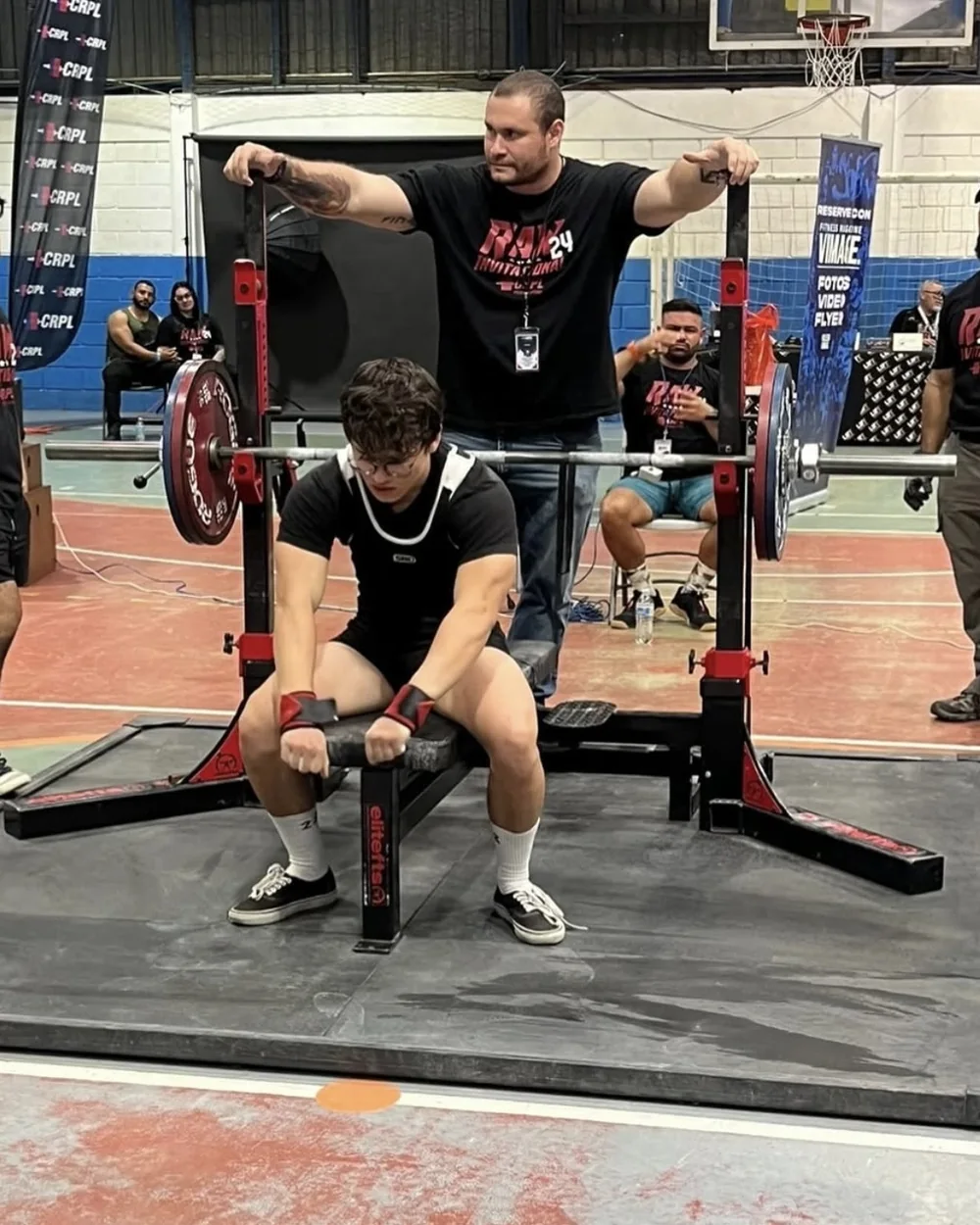 An athlete coached by Douglas Lutz setting up on the bench at a CRPL meet