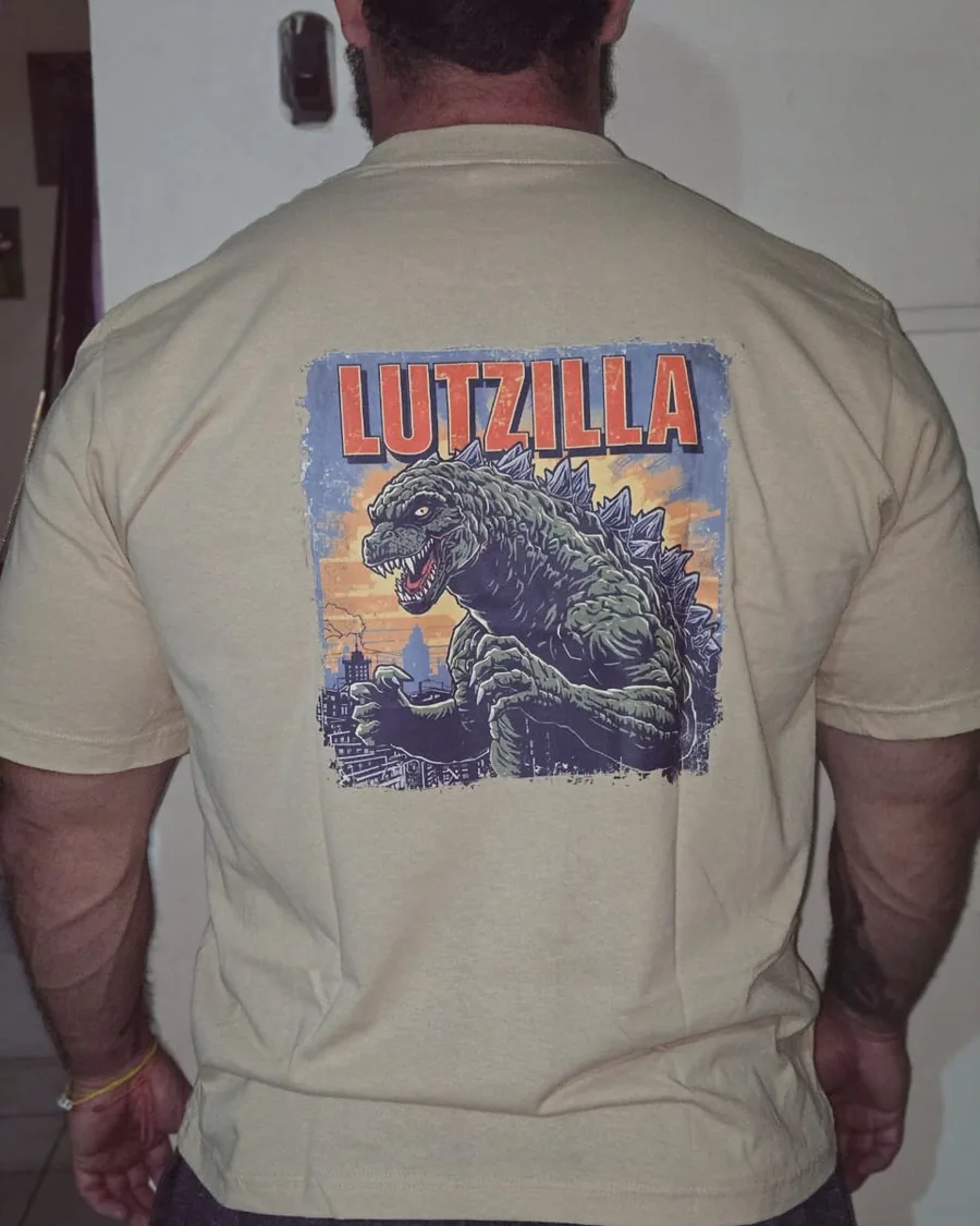 Douglas Lutz wearing the sand-coloured Lutzilla t-shirt, back print
