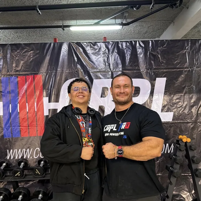 An athlete coached by Douglas Lutz holding a CRPL medal