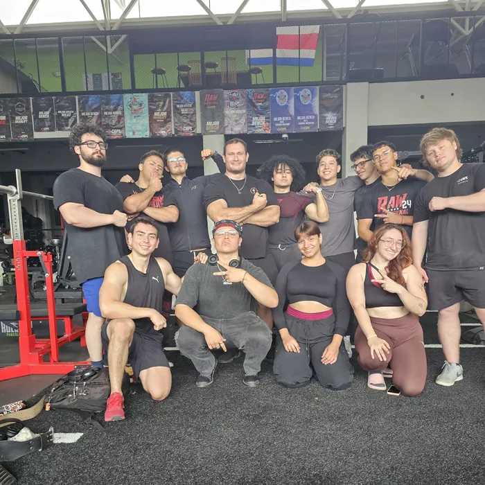 Douglas Lutz with a group of his athletes at the gym under the Costa Rica flag